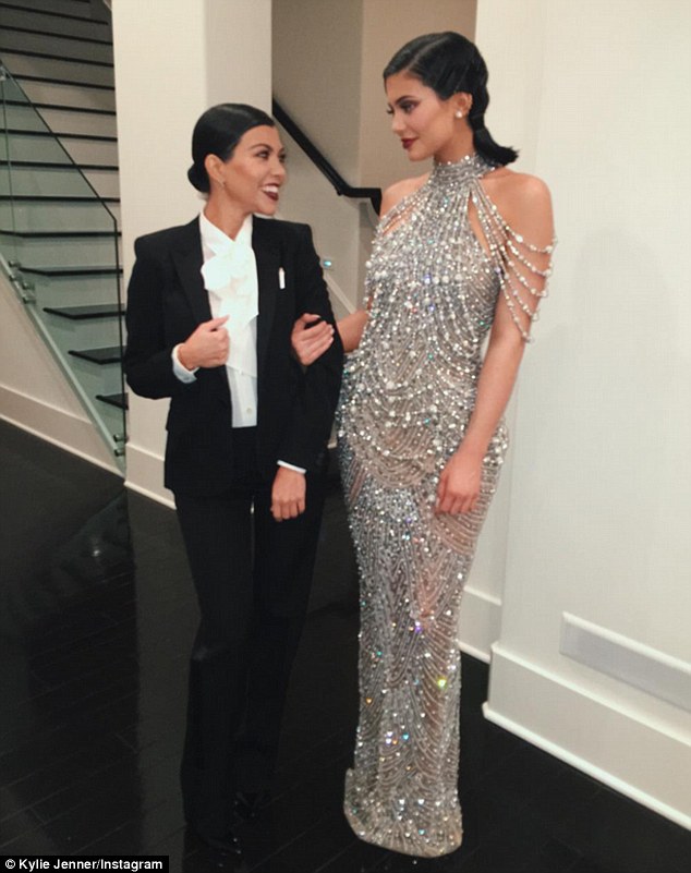 'My date': Kourtney gave her black fitted power suit a feminine touch by wearing full make-up and a white blouse featuring a pussy bow