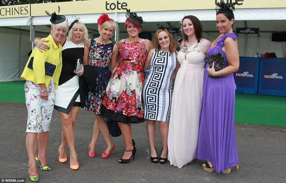 Enjoying the day: A group of colourfully dressed racegoers arrive to watch the action in pretty floral print, monochrome and modern brights
