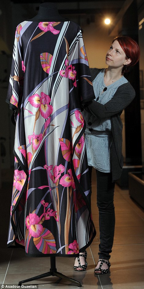 M&S archivist Helen Chatterton with a 1977 floral kaftan and right, man's casual attire c., 1980. She says these three decades are 'key to the development of technology'
