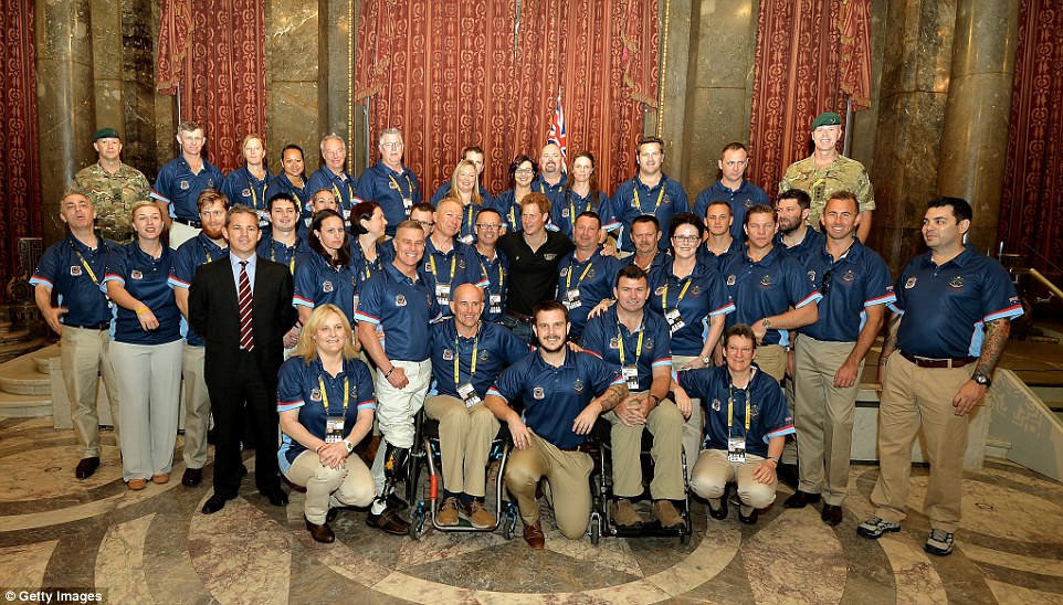 Prince Harry poses for a photo with the Australian Invictus team before they compete at the games over the next five days at Australia House earlier today