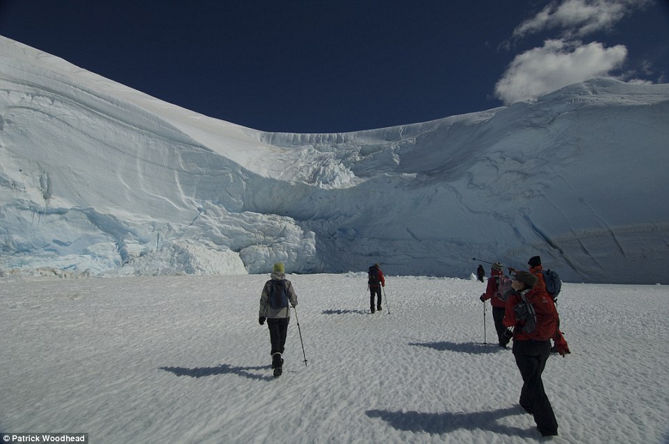 A group of White Desert clients trek off towards the huge icefall that dominates camp