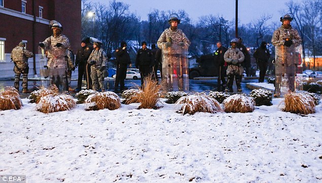 St. Louis County police are looking for an AR-15 rifle stolen from a police car that was set on fire Monday night during violent protests in Ferguson.