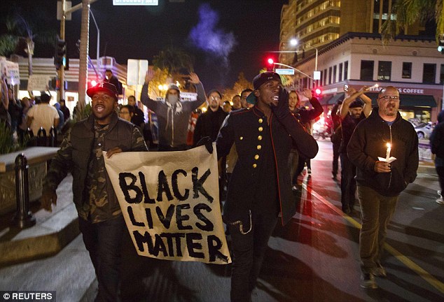 Protesters opposed to the grand jury verdict in the Michael Brown shooting in Ferguson, Missouri  take to the streets of Santa Ana, California, on Wednesday night