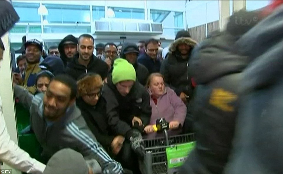 Hundreds of people push through the doors of Asda in Wembley, north London, this morning in a bid to get their hands on a bargain 