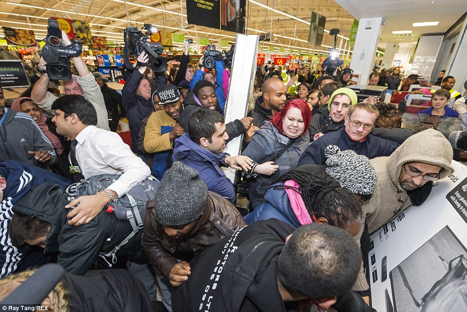 Shoppers scramble to get their hands on televisions, cooking appliances and other goods at Asda in Wembley, north London, this morning 