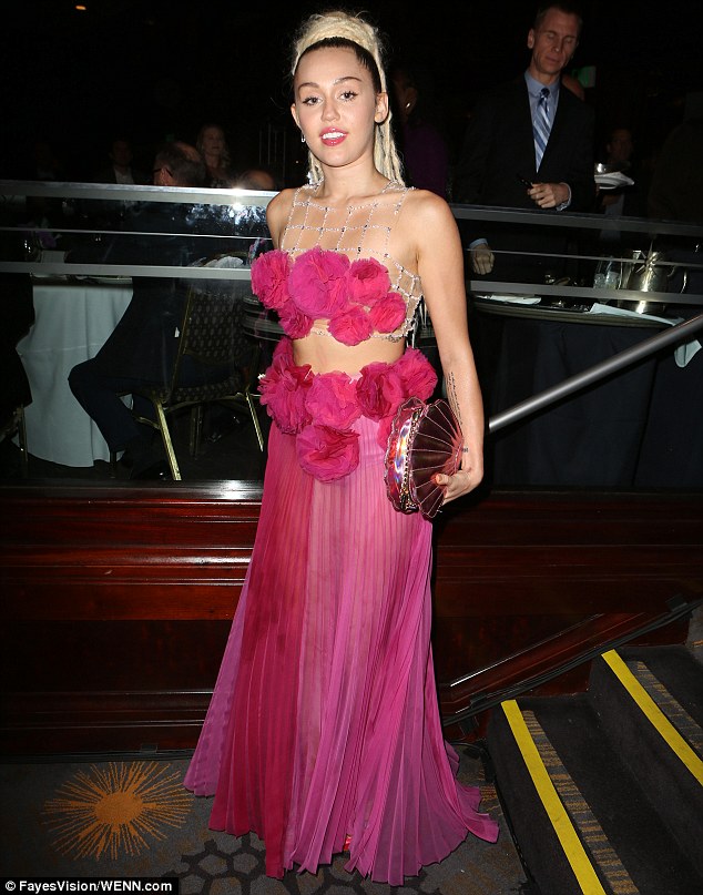 Never one for a quiet time: Collecting an award at the event, held at the Hyatt Regency Century Plaza, the 22-year-old singer showcased her taste for the dramatic when she licked and crawled over a signed white piano