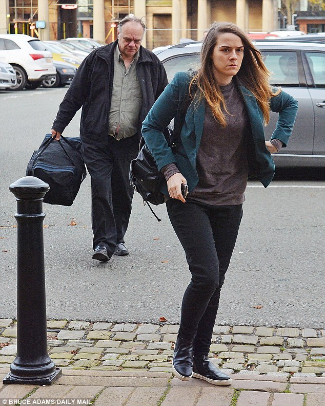 Arrival: Newland arrives at court this morning with a man carrying her prison bag behind her - although she had hoped to walk free with a suspended sentence