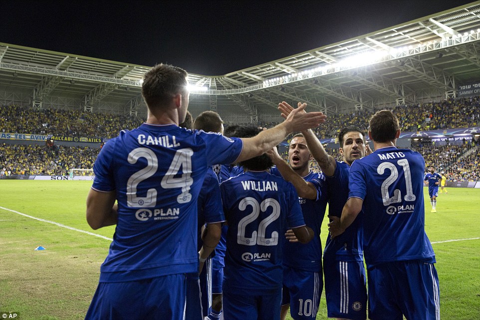 Cahill (far left) is congratulated by his Chelsea team-mates, including Cesc Fabregas who gives his the Englishman a high five 